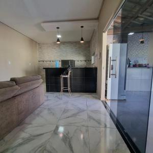 a living room with a couch and a kitchen at Espaço Acácia in Petrolina