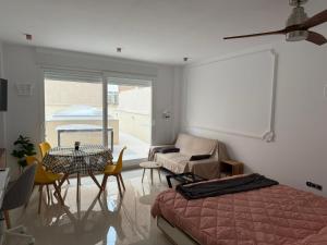 a bedroom with a bed and a table and chairs at Ecoloft Estudios in Cartagena