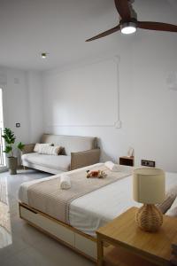 a bedroom with a large bed and a couch at Ecoloft Estudios in Cartagena