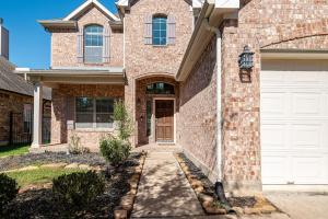 a brick house with a white garage door at Nice big house in Woodlands area in Spring
