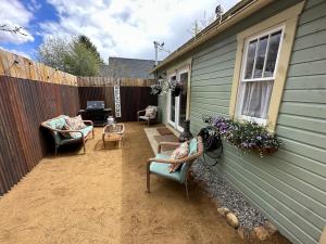 a backyard with two chairs and a fence at Bozeman Bungalow Downtown in Bozeman