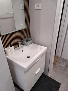a bathroom with a white sink and a mirror at Apartments by the sea Nin, Zadar - 23668 in Nin