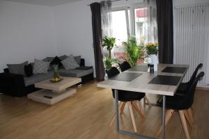 a living room with a table and a couch at Apartment Schiller in Lörrach