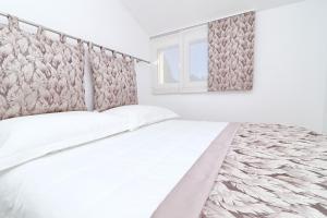une chambre blanche avec un lit et une fenêtre dans l'établissement Seaside family friendly house with a swimming pool Cove Slatina, Korcula - 23711, à Vela Luka 37 autres photos
