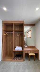 a room with a closet with shoes in it at Calma La Barka Resort by Raminten in Moyudan +3 photos