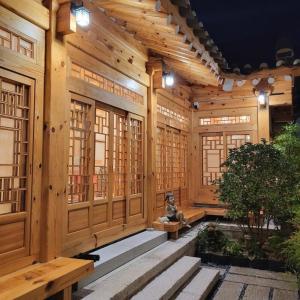 a wooden building with a statue sitting in the middle at Hanok Prince in Gyeongju