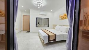 a bedroom with a bed and a room with a window at Lucky Hotel Uông Bí in Uông Bí +18 photos