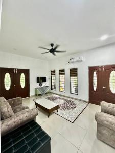 a living room with a couch and a table at Rumah D Hutan in Kampong Cheh