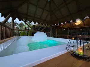 a large swimming pool with an umbrella at Villas Julieta in El Peñol