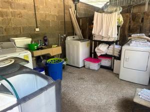 a laundry room with a bunch of old appliances at Casa Rustica Monteverde in Monteverde Costa Rica