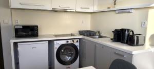 a kitchen with a washing machine and a sink at Zvolen Comfort Stay - Pohodlné Ubytovanie Zvolen in Zvolen +28 photos