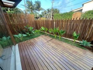 a wooden deck in front of a fence at Noronheiro Boutique & House in Fernando de Noronha