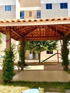 a large wooden structure in front of a building at Apartamento no Cond Vinhedos in Petrolina