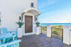 a house with a balcony with a door and the ocean at Emerald View on 30A in Santa Rosa Beach +7 photos