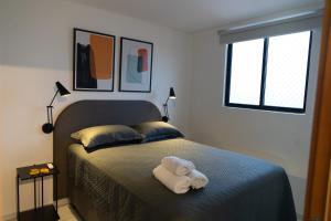 a bedroom with a bed with a towel on it at Paraíso em Tambauzinho in João Pessoa +20 photos