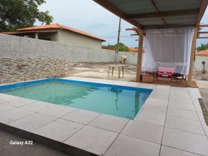 a swimming pool in a yard with a house at Pousada Nordestino in Salinópolis