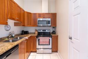 a kitchen with a stove and a microwave at Sunny Downtown Loft with AC, Unit #2 in Halifax