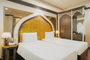 Voodi või voodid majutusasutuse Hotel Du Palace toas