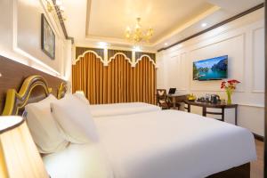 Voodi või voodid majutusasutuse Hotel Du Palace toas