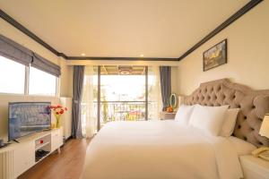 Voodi või voodid majutusasutuse Hotel Du Palace toas