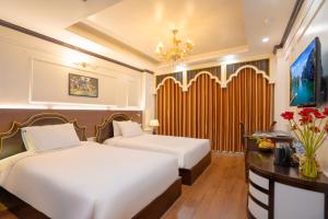 Voodi või voodid majutusasutuse Hotel Du Palace toas