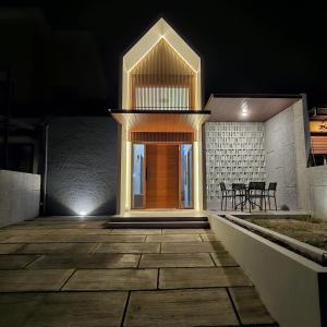 a front door of a house at night at 3 Bedroom House Near Grand Batam Mall in Bagam