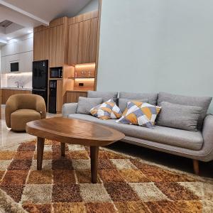 a living room with a couch and a coffee table at 3 Bedroom House Near Grand Batam Mall in Bagam