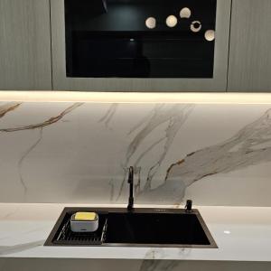 a kitchen counter with a sink and a microwave at 3 Bedroom House Near Grand Batam Mall in Bagam +86 photos