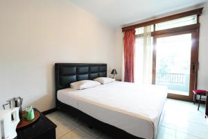 Postel nebo postele na pokoji v ubytování De'Qur Hotel Bandung
