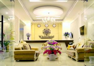 a store with couches and flowers in a room at White Hotel Nghệ An in Vinh +17 photos