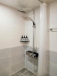 a bathroom with a shower with a glass door at Bongbong Stay in Seoul