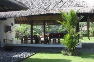 Un pabellón con una mesa y sillas en un complejo turístico. en Pool villa not overlooked, en Montongbuwoh 14 fotos más