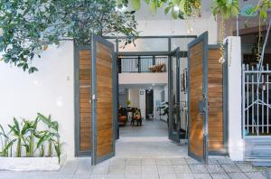 an open door to a house with a porch at Cozy Modern Loft near the Beach I tourist quarter in Da Nang