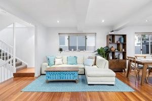 a living room with a couch and a table at Pool side Luxury pet friendly - walk to the beach in Alexandra Headland