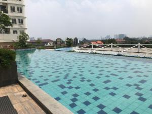 a large swimming pool on the side of a building at Classic and Cozy Studio at Cinere Bellevue Suites Apartment By Travelio in Depok