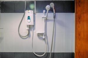 a shower in a bathroom with a shower head at Classic and Cozy Studio at Cinere Bellevue Suites Apartment By Travelio in Depok