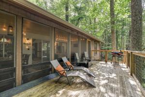 a screened in porch of a house in the woods at Treetop Hideaway - Summer Escape with HOT TUB in Gatlinburg