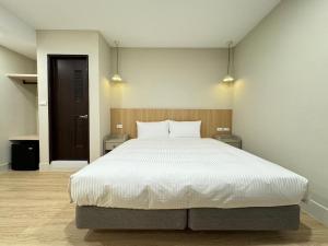 Postel nebo postele na pokoji v ubytování Yoshi Hotel - Tainan Sinmei Branch