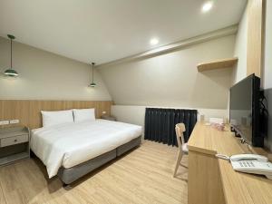 Postel nebo postele na pokoji v ubytování Yoshi Hotel - Tainan Sinmei Branch