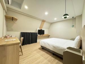 Ένα ή περισσότερα κρεβάτια σε δωμάτιο στο Yoshi Hotel - Tainan Sinmei Branch
