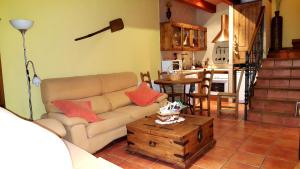 a living room with a couch and a table at Madre Terra in La Puebla de la Sierra