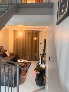 a living room with a couch and a table at Fatisa homes in Kampala +3 photos