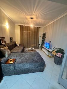 a living room with a couch and a tv at Fatisa homes in Kampala