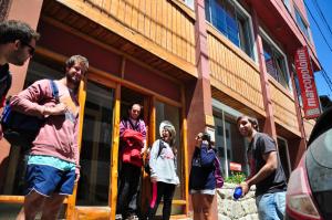 people standing in front of a building at Marcopolo Inn Hostel Bariloche in San Carlos de Bariloche
