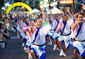 a group of people dancing in a parade at SSr大和町1丁目 in Tokyo