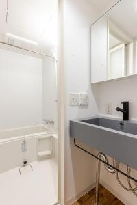 a bathroom with a sink and a mirror at SSr大和町1丁目 in Tokyo