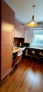 a kitchen with a sink and a desk and a window at Central One Guesthouse in Reşiţa