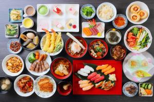 a table topped with plates of food and bowls of food at Onyado Toho in Aizuwakamatsu