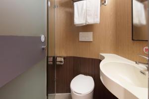 a bathroom with a white toilet and a sink at Mcsrh Hotel-Chengdu Chunxi Road in Chengdu