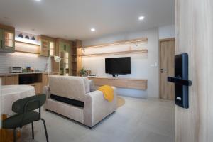 un salon avec un canapé et une télévision dans l'établissement Peaceful Townhouse in Sathorn Near Saint Louis BTS, à Yan Nawa